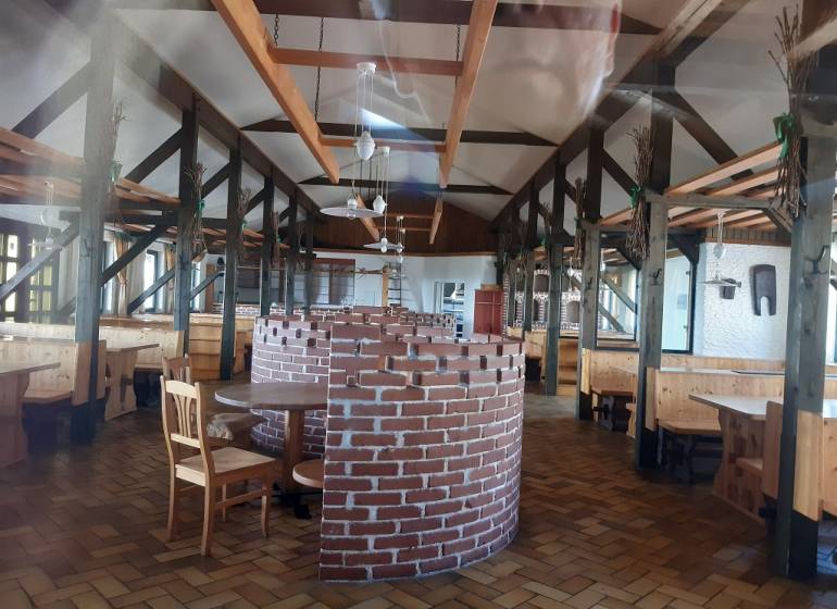 Interior of a restaurant with a brick fireplace on Hornerstraße, ideal for gastronomy spaces.