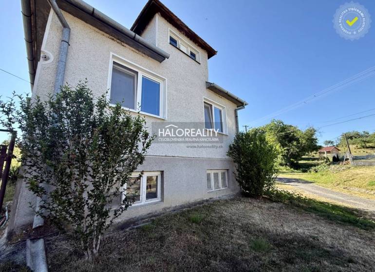 A family house in Padarovce with two floors near a garden and a road, surrounded by greenery.