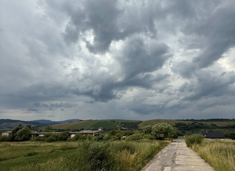 Landscape with clouds and a country road in Ľubotín, ideal for commercial land.