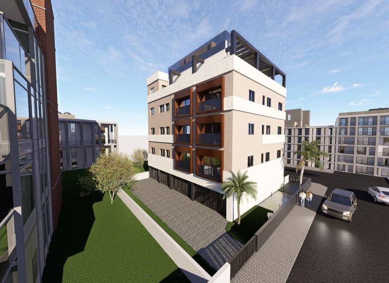 Residential complex in San Pedro del Pinatar with palm trees and parking in front of 3-bedroom apartments.
