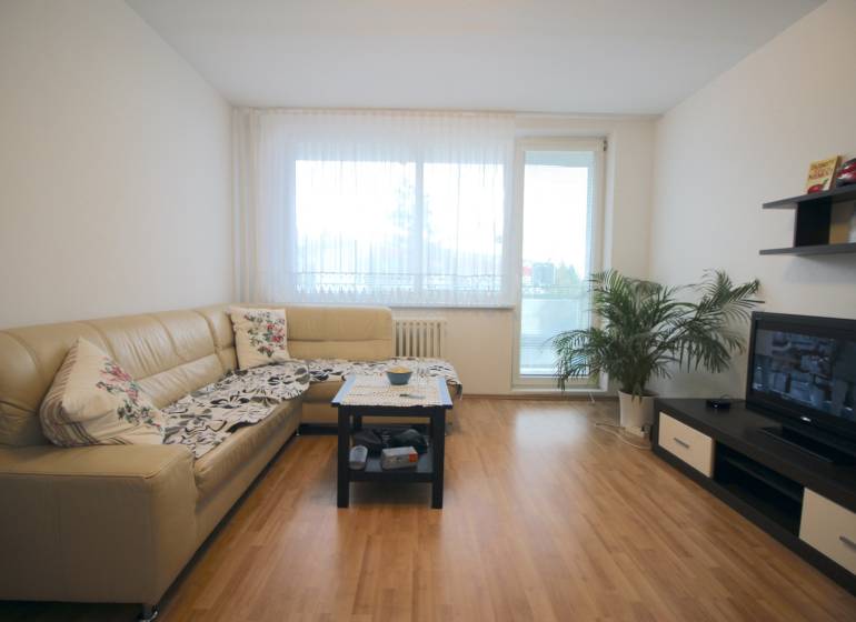 Living room in a 3-room apartment with a corner sofa and a television.