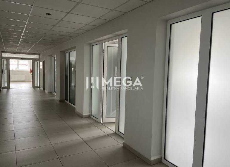 Offices with a corridor and doors, featuring a suspended ceiling and tiles.