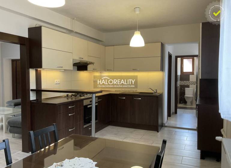 A kitchen unit with a dining table in a family house, including bright lighting and tiles.