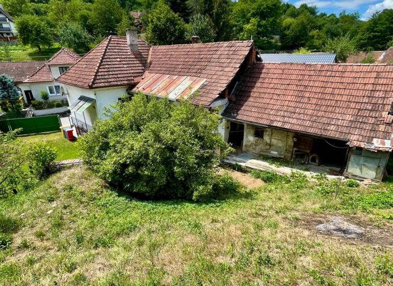 A family house in Horná Súča surrounded by greenery with a traditional red tile roof.