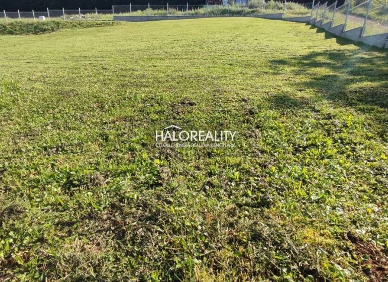 A garden in Horná Ves suitable for residential plots, covered with grass and fenced.