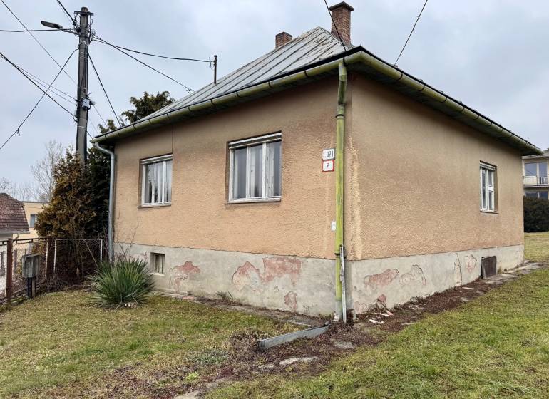 A house on Lietavská Lúčka street with a large yard and a gray roof.