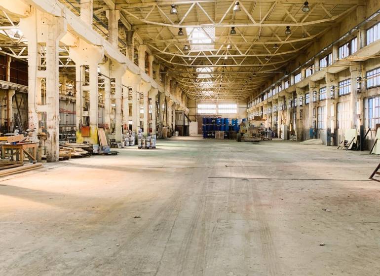 Industrial interior with high ceiling and steel construction. Warehouses and halls.