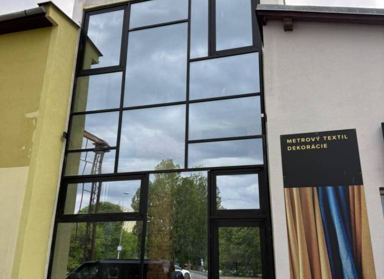 Glazed commercial spaces in Poprad with advertising for textile decorations.