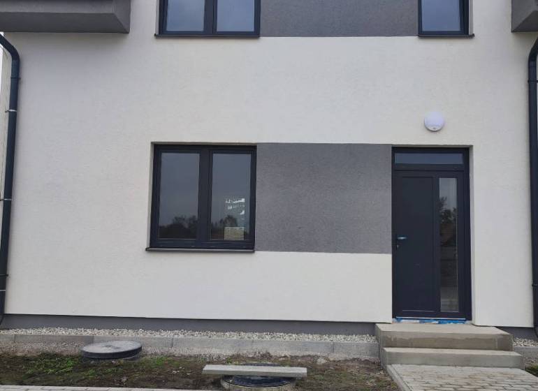 A family house in Zemianska Olča with two floors and a paved area on Zemianska Olča street.