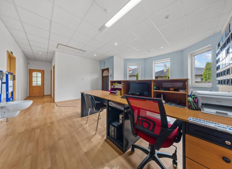 Office in a family house with a desk, computer, and wooden floor.