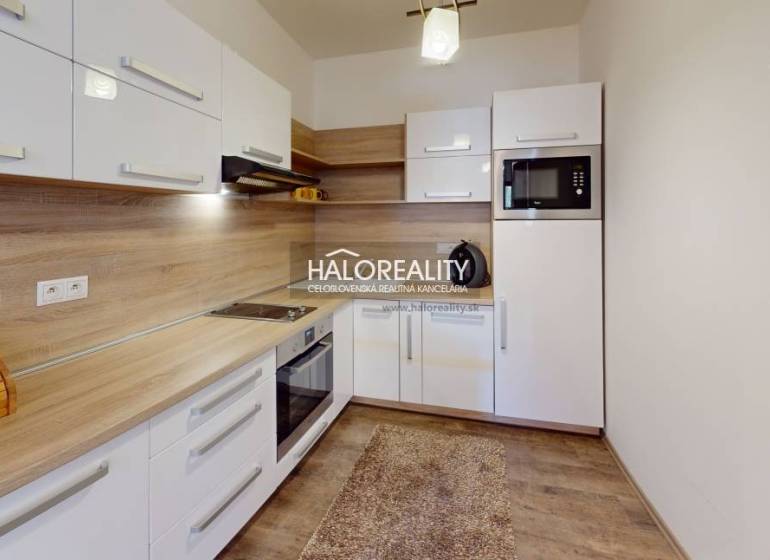 A kitchen with wooden details and appliances in a 3-room apartment, light cabinet set.