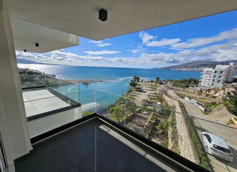 Balcony of a holiday apartment in Sarandë with a view of the sea and coastal landscape.