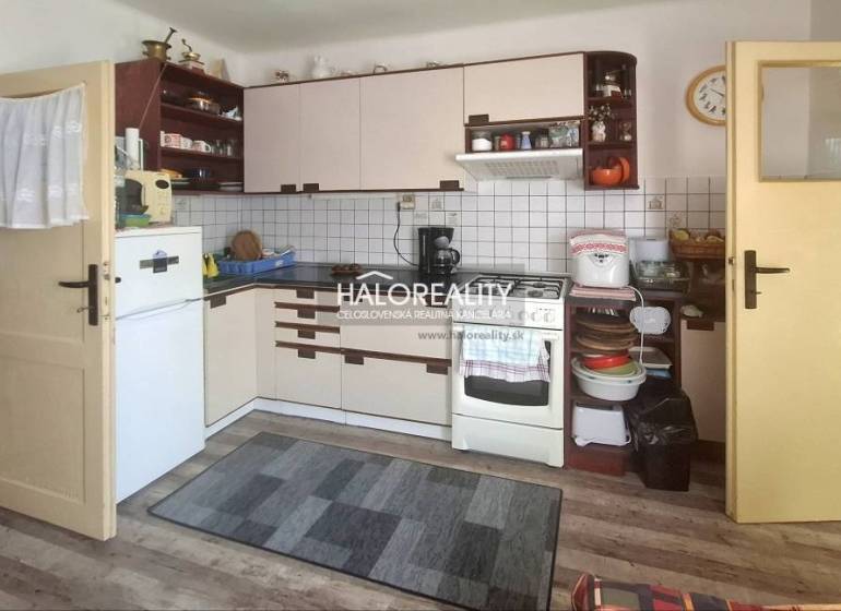 A kitchen in a family house with a countertop, stove, and refrigerator, without people present.