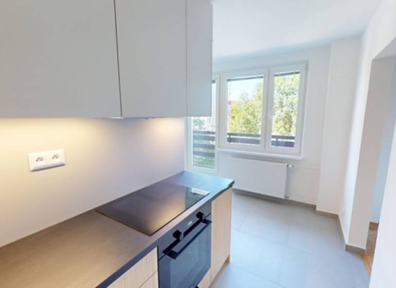 Kitchen in a 2-room apartment with a view, bright walls and windows.