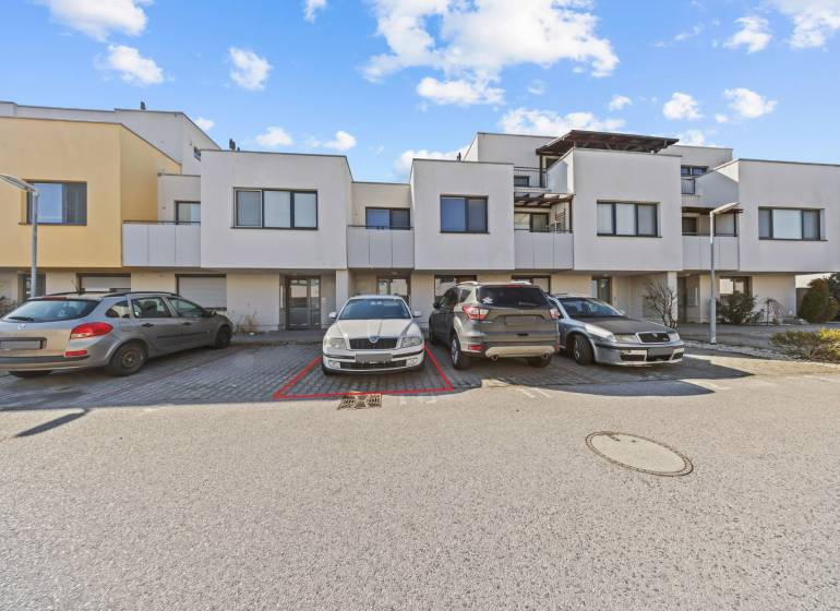 On Mesačná Street, there is a parking lot in front of the row houses and an outdoor 2-room apartment.