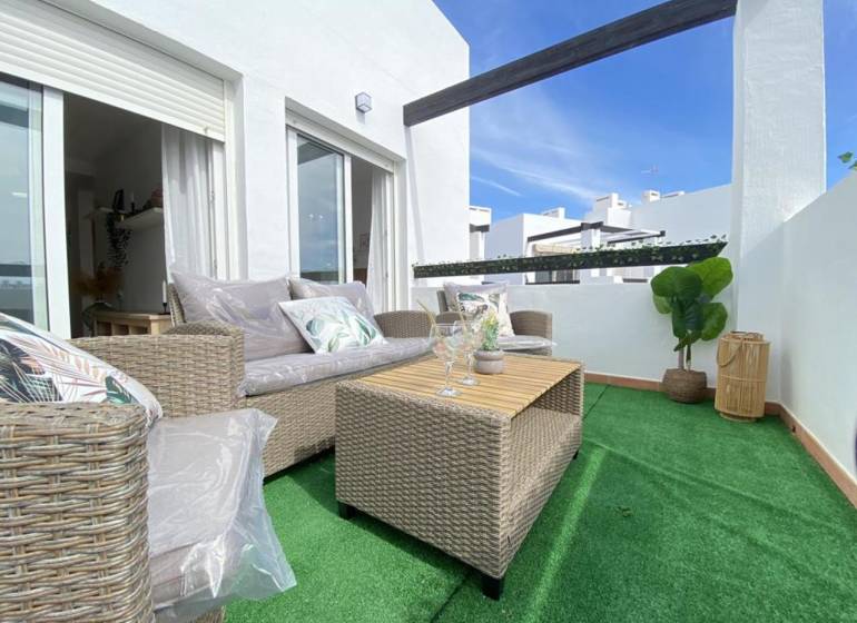 A terrace with comfortable seating and a table in a 3-room apartment.