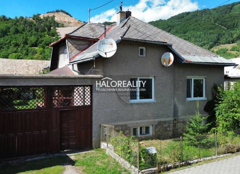 A family house in Tisovec, surrounded by nature, with satellite dishes on the roof.