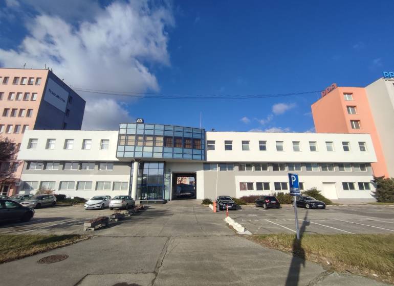 Offices on Vajnorská Street, Bratislava - Nové Mesto, with a parking area and cars.