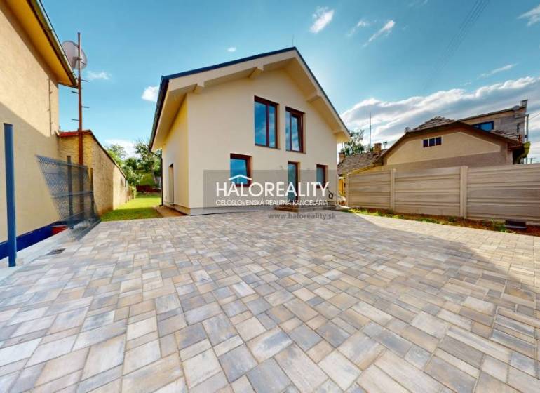 A family house in Rimavská Sobota with a paved yard and lawn on a spacious plot.