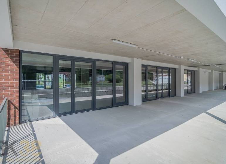 Commercial premises in the town of Svit with a glass entrance and a concrete ceiling.