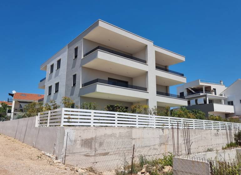 The exterior of a 4-room apartment in the city of Vodice shows a modern new building.