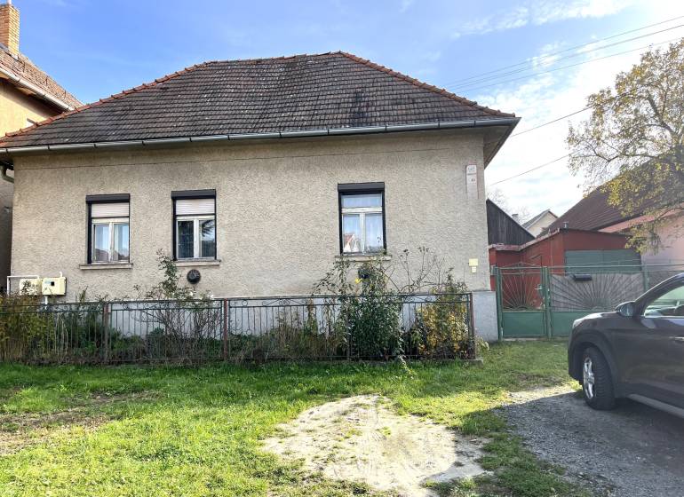 A family house on Partizánska Street in Detva with a garden and an entrance gate.