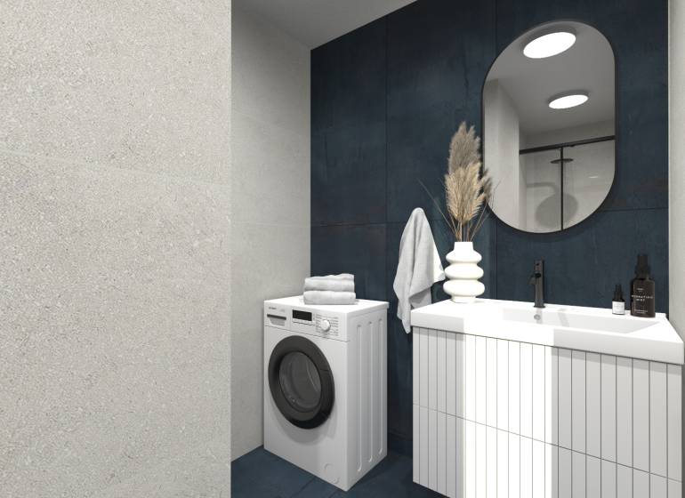 A bathroom in a 2-room apartment with a washing machine, sink, mirror, and decorative elements.
