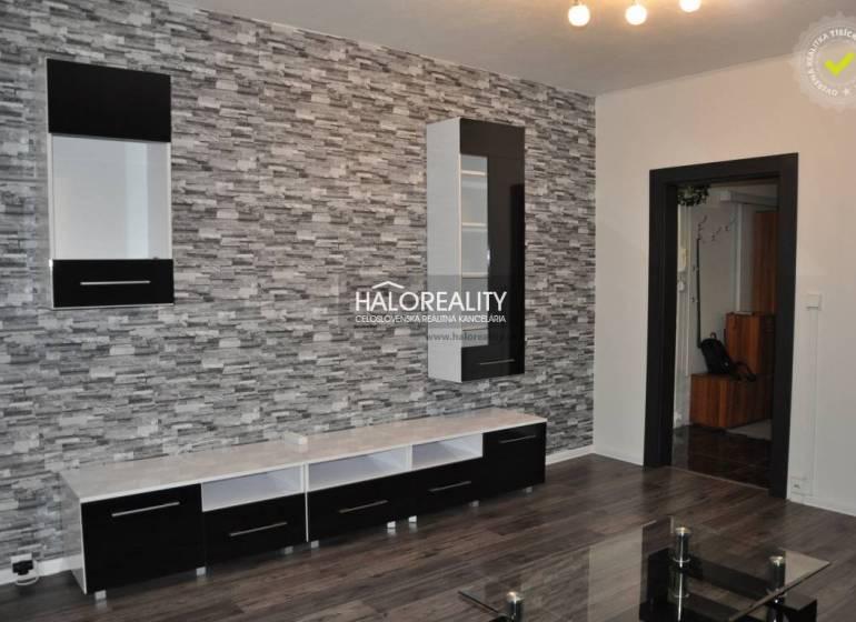 Living room in a 3-room apartment with a decorative wall and modern furniture.