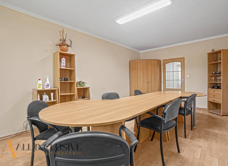 Meeting room: wooden table, chairs, cabinets, and shelves in the office.