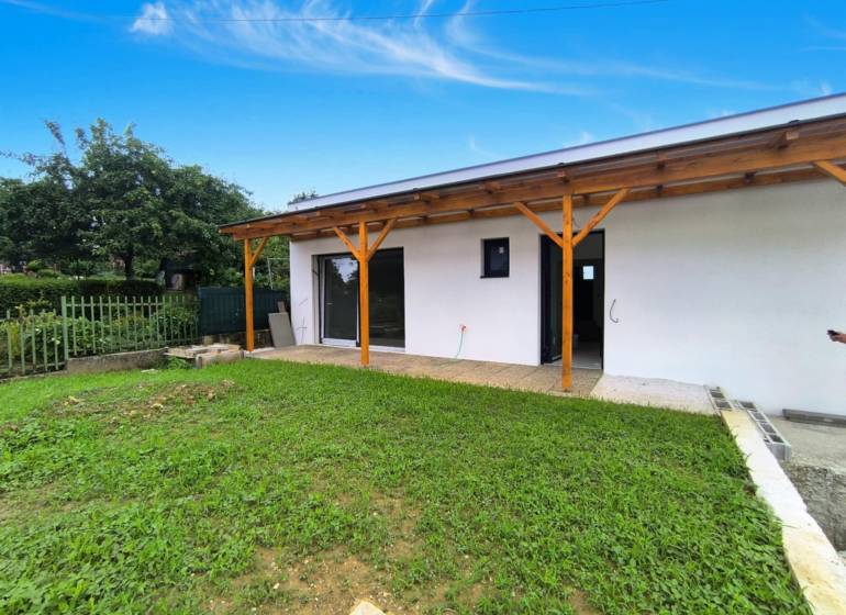 A family house in Malé Kršteňany with a garden and a wooden terrace.