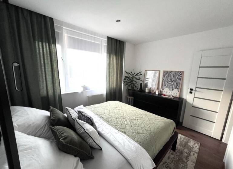 Bedroom in a 4-room apartment with stylish decor and furniture.