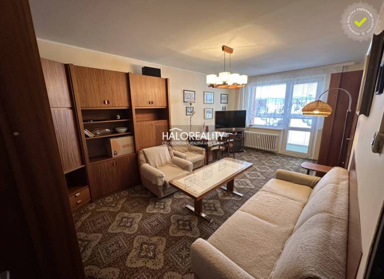 A stylish living room in a 3-room apartment with a sofa, an armchair, and curtains.