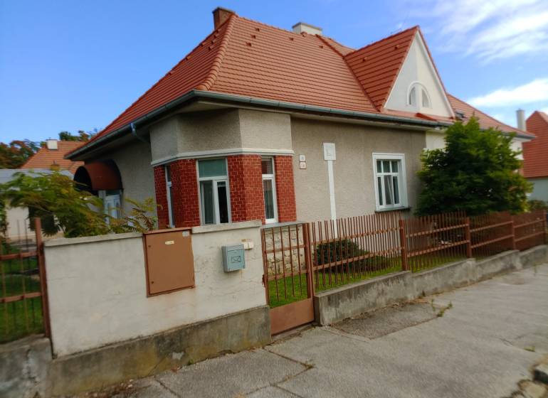 A family house on Nécseyho Street in Nitra with a red roof and brick facade.
