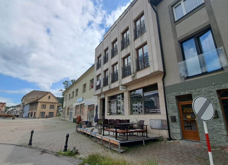 The building on Mostová Street in Ružomberok with a terrace and surrounding historical structures.