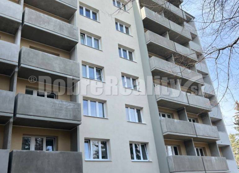 A multi-story building with gray balconies and windows on T. Vansovej Street, suitable for a 1-room apartment.