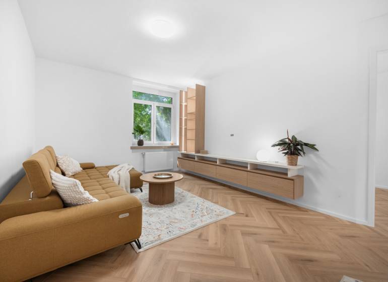 Living room in a 3-room apartment with a sofa, coffee table, and wooden floor.
