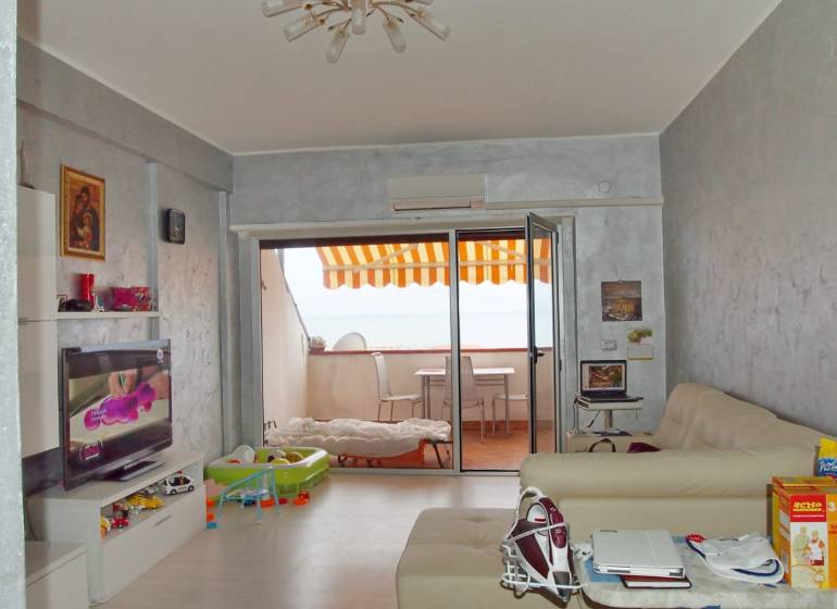 Living room in a 3-room apartment with a terrace, television, and comfortable sofas.