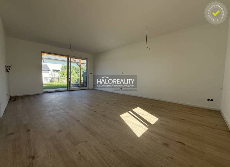A spacious living room with wooden flooring in a family house.