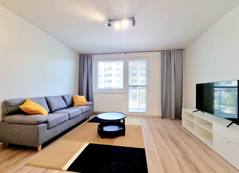 Living room with a sofa and a television in a 3-room apartment.