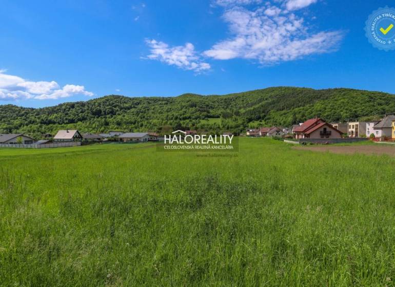 Greenery and panorama in Udiča, plots - housing with houses and wooded hills in the background.