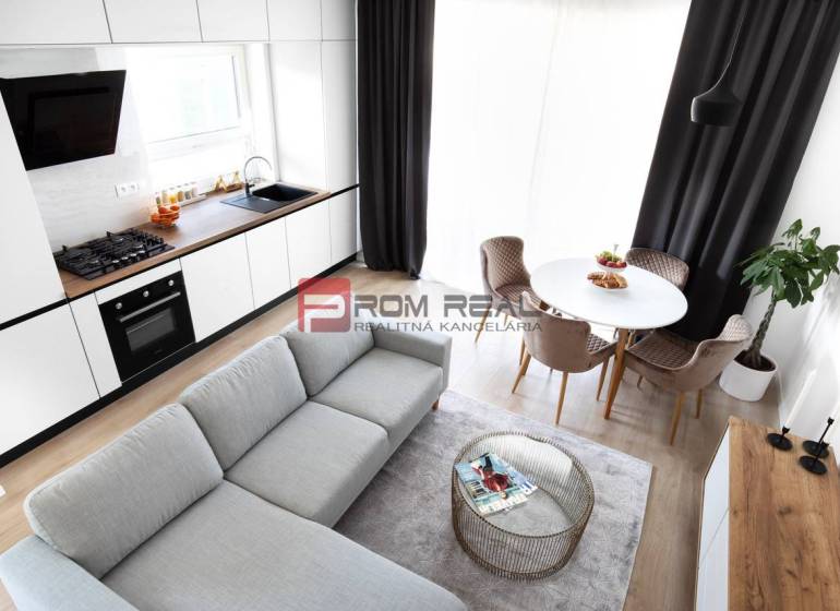 A bright kitchen connected to the living room, a dining nook, and stylish armchairs in a 3-room apartment.