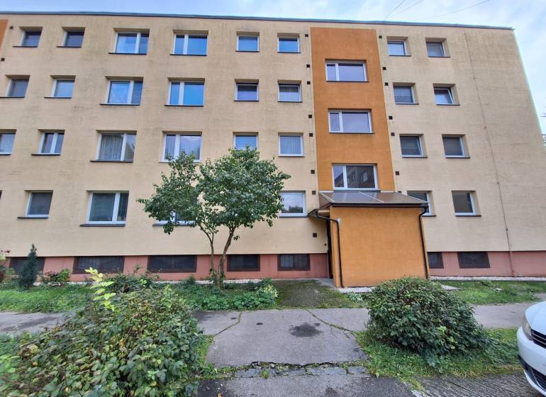A four-story apartment building surrounded by greenery in Martin, offering 3-bedroom apartments.