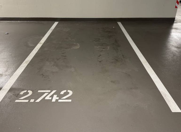 Parking space inside the Garage with number 2.742 and white lines.