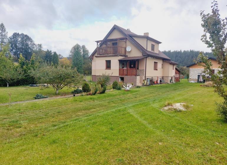 A family house in Liptovská Porúbka with a large garden and fruit trees.