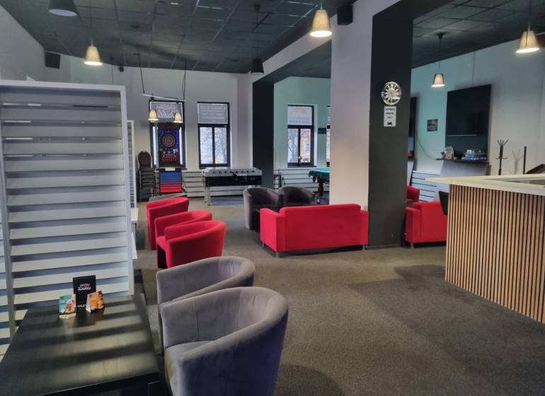 Commercial spaces with sofas and games, including table football and darts.