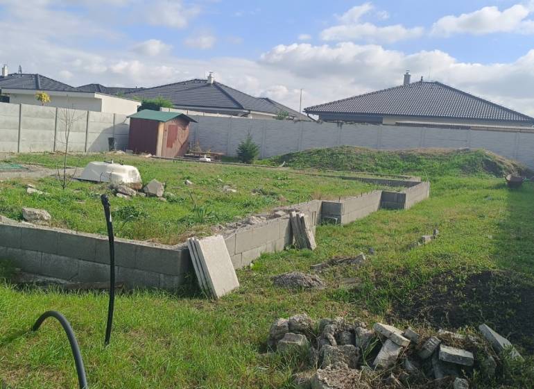 A residential plot in the Youth District of Galanta with a green area and a fence.