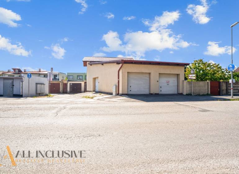 Parking lot with garages in commercial premises in Dunajská Streda under the blue sky.