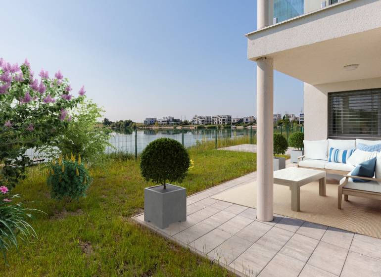Terrace with a 4-room apartment in Kittsee, Am Seepark with a view of the lake and a garden.