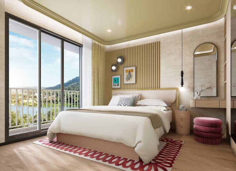 Bedroom in a two-room apartment with a bed, balcony doors, and a floor with a wooden decor.