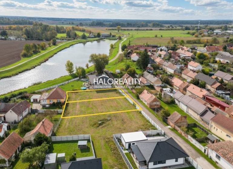 Land - housing in Brodské by the river, surrounded by houses and nature.